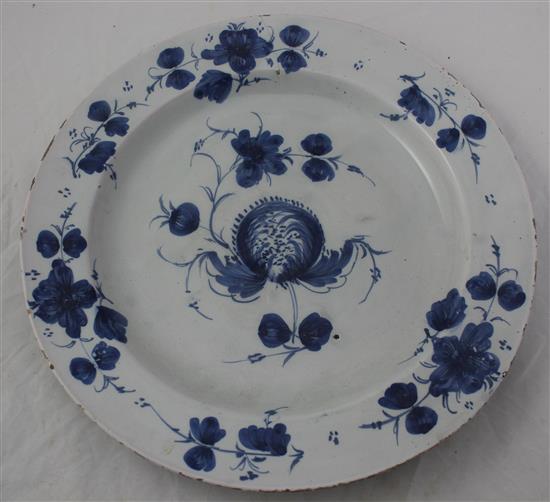 A Glasgow delft ware charger and a similar plate, late 18th century, 35.5cm and 22.5cm, hairline crack to charger